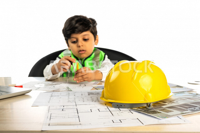 بورتريه لفتى عربي خليجي سعودي داخل مكتب هندسي ، إستخدام جهاز الحاسوب المحمول للبحث ، خوذة الوقاية ، الرسم بإستخدام أدوات ومعدات هندسية ، يرتدي سترة الحماية الخاصة بالعمل ، مهنة مستقبلية ، خلفية بيضاء ، مفهوم الهندسة المعمارية ، مهن ووظائف هندسية