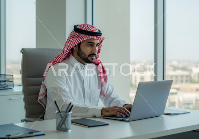 Managing and completing tasks using a modern and advanced technical device, a close-up of a smiling Saudi Arabian Gulf man wearing traditional clothing working on a laptop, gestures and expressions of pleasure and happiness, Saudi office jobs and professions, writing and recording data and results