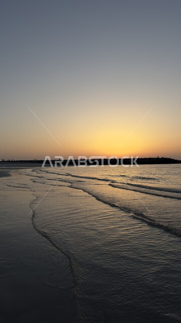 The beach coasts and waterfront in Sharjah, a destination for tourists from all over the world, famous coastal tourist attractions and places in the United Arab Emirates, enjoying the calm sea waves at sunset