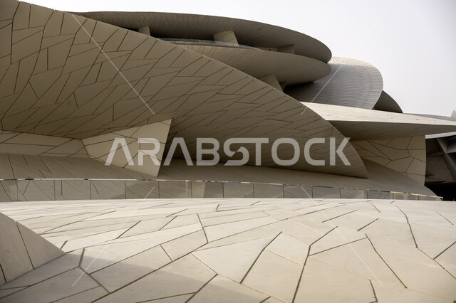 Modern architectural art, the geometric formation of the Qatar National Museum building on the Doha Corniche, famous landmarks, museums and palaces in Qatar, urban growth and progress, tourist attractions and attractions to learn about Qatari heritage and civilization