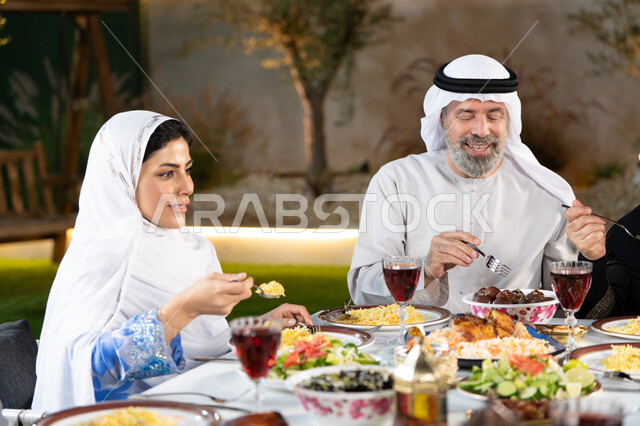 Ramadan breakfast and Friday gatherings of family and friends for breakfast, an Arab Gulf Emirati family gathered around a dining table filled with the most delicious foods, Islamic occasions and holidays, the joy of family gatherings
