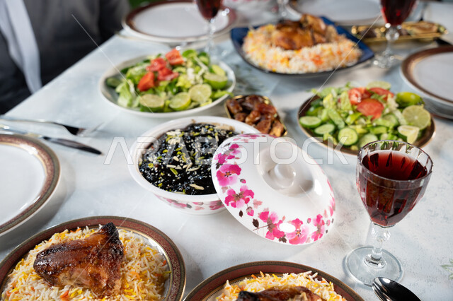 Traditional food and popular dishes, a close-up photo of a table filled with a variety of delicious foods, a varied Ramadan iftar table, healthy food recipes and dishes, a spiritual Islamic atmosphere, and special lunch meals.