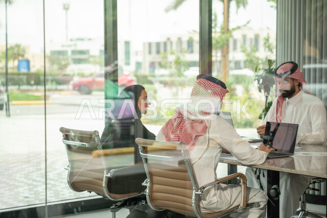 شرح و تحليل الرسوم البيانية, دمج الأجهزة التقنية الحديثة بالأعمال المكتبية، دراسة أوراق البيانات الإحصائية, تطوير المشاريع و الاستثمارات, إدارة و تقسيم المهام، فريق عمل عربي خليجي سعودي يقوم بإجراء اجتماع عمل داخل غرفة الاجتماعات في مقر الشركة