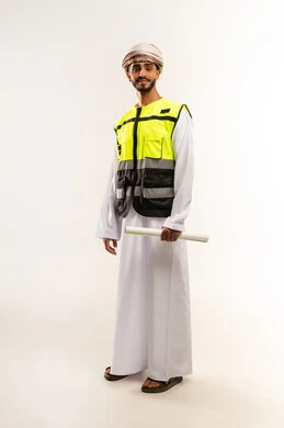 Working in the field of engineering, supervising engineering project plans, the concept of engineering and architectural construction, a portrait of an Arab Gulf Omani engineer wearing a dishdasha, a keffiyeh and a protective vest, holding a planner in his hands, professions and jobs for young people in the Sultanate of Oman, a full-length body image, a white background.