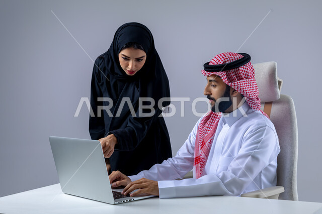  مناقشة وتوزيع مهام العمل، تطوير العمل وحل المشكلات، مهن ووظائف سعودية مكتبية، تبادل الاراء والخبرات، بورتريه لرجل وسيدة اعمال عربيان سعوديان خليجيان في مقر الشركة، ادارة العمل باستخدام الحاسب المحمول، الوحده والعمل الجماعي، تحقيق اهداف الشركة، خلفية بيضاء