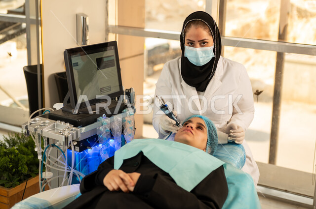 Omani woman taking care of exfoliation, lightening and massage routine, women's skin care centers, skin cleansing steps, women's beauty clinic, beautician performing skin care sessions, close-up of a Saudi Arabian Gulf woman in a women's beauty salon with relaxing gestures, the concept of femininity and softness, interest in improving the skin.