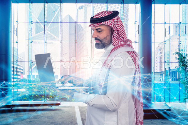 رجل اعمال عربي سعودي خليجي يستخدم جهاز تفني لمتابعة الأعمال المكتبيه, رسومات هولوجراميه توضح نسبة انجاز الاعمال, متابعة سوق الاسهم, الاقتصاد المالي, اعمال الكترونيه تجاريه, حسابات واحصاءات بيانيه باستخدام تقنية الهولوجرام ثلاثية الابعاد