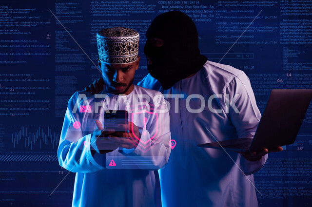 Use of computer for illegal purposes, cyber security intrusion, hacking and data theft, algorithms to destroy digital accounts, two masked Gulf Arab Omani hackers wearing dishdashas working in the field of digital piracy