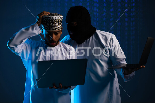 Hacking and data theft, cybersecurity intrusion, using a computer for illegal purposes, algorithms to destroy digital accounts, two masked Gulf Arab Omani hackers wearing dishdashas working in the field of digital piracy