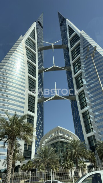 Bahrain World Trade Center overlooking the sea during the day, the architectural art of towers, buildings and skyscrapers in Manama, famous tourist attractions, urban growth and progress in the capital, modern and advanced architectural designs