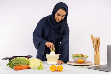 اعداد المشروبات الصحية، اتباع نظام غذائي صحي، تعلم مهارة الطهي باستخدام الحاسوب، بورتريه لسيدة عربية خليجية اماراتية محجبة ترتدي عباءة تقوم بعصر الليمون، ربة منزل سعودية تقوم بتحضير طبق مفيد، مشاركة الوصفة عبر مواقع التواصل الاجتماعي، خلفية بيضاء
