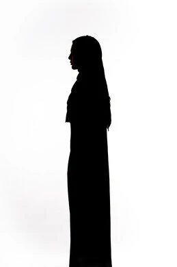 Silhouette of an Emirati Gulf Arab woman standing straight and confident, modern, elegant veiled fashion, the concept of elegance and interest in outward appearance, white background