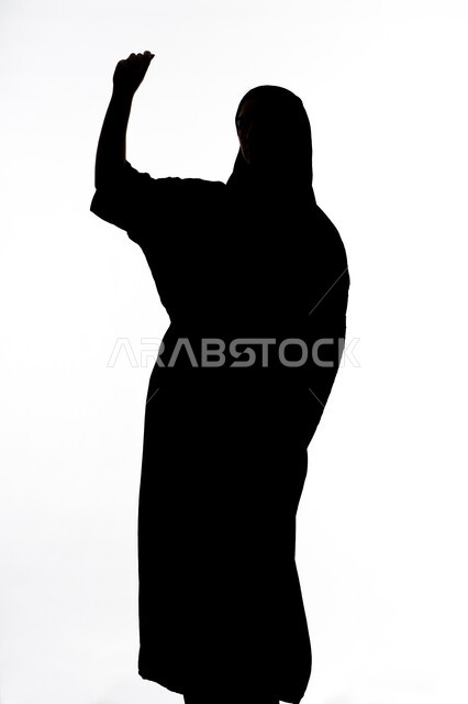 قضاء أوقات الفراغ باللعب والترفيه ،تعابير الفوز و الانتصار, تقنيات حديثة مسلية, صورة ظلية لإمرأة عربية اماراتيه خليجية ترفع يدها بايماءات الحماس ، خلفية بيضاء