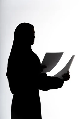 Education and culture, following up on plans and projects, reading notes and information, silhouette of an Emirati Gulf Arab woman, holding work papers, research and reports, white background