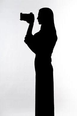 Taking souvenir photos, high-resolution camera, professional photography, photography hobby, silhouette of an Arab Gulf Emirati woman, holding a high-resolution camera, Emirati photographer, white background