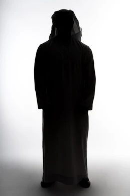 Caring about one's appearance, the concept of masculinity and elegance, standing up straight and confident, silhouette of an Arab Gulf Emirati man, white background