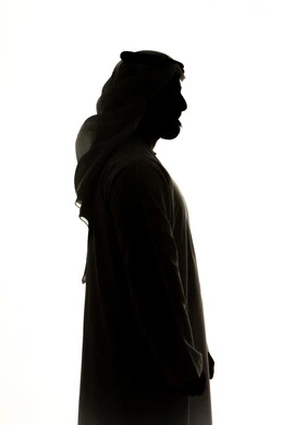 Concern for elegance and outward appearance, the concept of masculinity and self-confidence, a side-view silhouette of an Arab Gulf Emirati man, white background