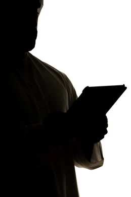 Completing tasks remotely, online shopping using a tablet, integrating modern technologies into daily life, silhouette of an Arab Gulf Emirati man, professions and jobs, white background