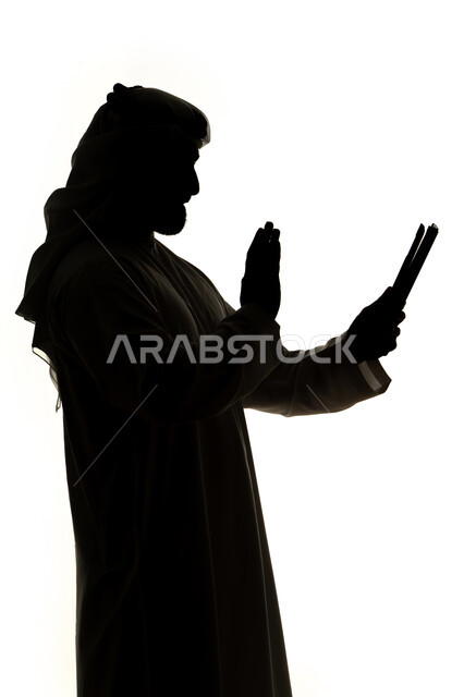 Making a video call using a mobile phone, chatting online, integrating modern technologies into daily life, completing tasks remotely, social networking, communication and chatting, silhouette of an Arab Gulf Emirati man, white background