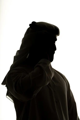 Integrating modern technologies into daily life, completing tasks remotely, social networking, making a video call using a mobile phone, calling and chatting, online chatting, silhouette of an Arab Gulf Emirati man, white background