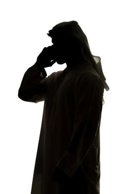 Doing tasks remotely, social networking, making a video call using a mobile phone, calling and chatting, chatting online, integrating modern technologies into daily life, silhouette of an Arab Gulf Emirati man, white background