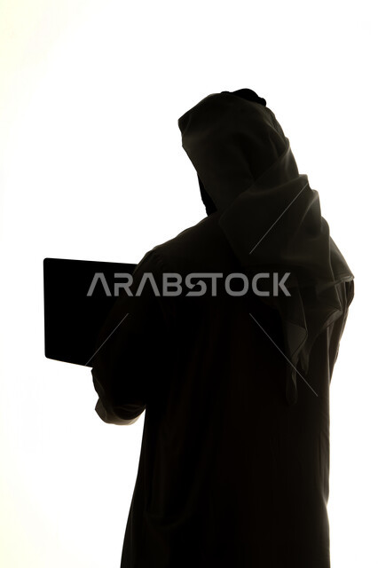 Use of technology devices, integration of modern technologies into daily life, surfing the internet, silhouette of an Arab Gulf Emirati man, using a laptop, remote work, e-marketing, professions and jobs, white background