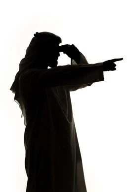 Determining a specific location, looking at something, signs and hand movements indicating this place (here), silhouette of an Arab Gulf Emirati man pointing his fingers to a specific target, white background