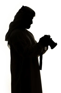 Taking souvenir photos, photography hobby, high-resolution camera, silhouette of an Emirati Gulf Arab man, holding a high-resolution camera, Emirati photographer, professional photography, white background