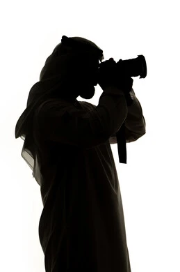 هواية التصوير ،كاميرا عالية الدقة ،صورة ظلية لرجل عربي خليجي اماراتي ، يحمل بيده كاميرا تصوير عالية الدقة ، إلتقاط الصور التذكارية ، مصوره اماراتي ، إحتراف التصوير ، خلفية بيضاء