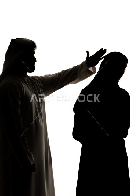 Family arguments and misunderstandings, family problems and conflicts, crisis in family relations, concept of violence against women, silhouette of an Arab Gulf Emirati couple, quarreling with each other, crisis in family relations, family conflict, quarrel between spouses, white background