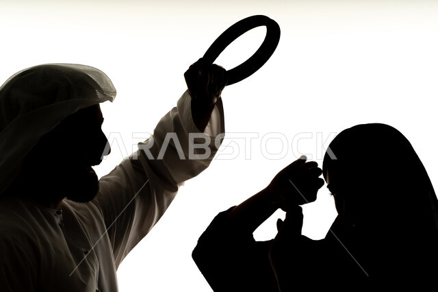 Ending violence against women, family problems and conflicts, arguments and misunderstandings, quarrel between spouses, crisis in family relations, silhouette of an Arab Gulf Emirati couple, quarreling with each other, white background
