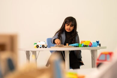 Performing many fun activities, spending happy times, kindergartens and nurseries, an Omani girl engaging in various activities, games for entertainment and leisure, enjoyment during the summer vacation.