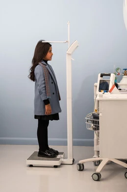 Using a scale to measure weight, the concept of health and fitness, excess weight and obesity, the accumulation of calories, a Saudi Arabian Gulf girl with a full body suffering from obesity, suffering from health problems.