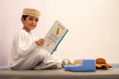 Kindergartens and nurseries, performing many fun activities, spending wonderful times, an Omani child wearing traditional Omani attire engaging in various activities, games for fun and entertainment, enjoyment during the summer vacation. Kindergartens and nurseries, performing many fun activities, spending wonderful times, an Omani child wearing traditional Omani attire engaging in various activities, games for fun and entertainment, enjoyment during the summer vacation.