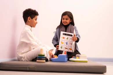 Kindergartens and nurseries, performing many fun activities, two Omani children engaging in various activities, spending wonderful times at the amusement park, games of fun and entertainment, enjoyment during the summer vacation.