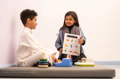 Kindergartens and nurseries, performing many fun activities, two Omani children engaging in various activities, spending wonderful times at the amusement park, games of fun and entertainment, enjoyment during the summer vacation.