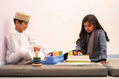 Two Omani children are playing in the amusement park, having a great time in the amusement city, enjoying games and entertainment, and having fun during the summer vacation. Two Omani children are playing in the amusement park, having a great time in the amusement city, enjoying games and entertainment, and having fun during the summer vacation.