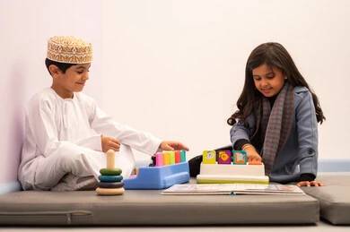 Kindergartens and nurseries, games for fun and entertainment, performing many enjoyable activities, two Omani children engaging in various activities, spending wonderful times at the amusement park, enjoyment during the summer vacation.