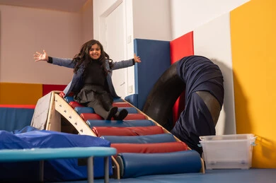 The amusement park in the Kingdom of Saudi Arabia, enjoyable summer atmosphere, a Gulf Arab Omani girl enjoying sliding down the slide, enjoying recreational games, fun and entertainment games.