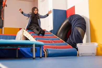 Enjoying recreational games, fun summer atmosphere, amusement park in the Kingdom of Saudi Arabia, an Arab Gulf Omani girl enjoying sliding down the slide, games of entertainment and fun. Enjoying recreational games, fun summer atmosphere, amusement park in the Kingdom of Saudi Arabia, an Arab Gulf Omani girl enjoying sliding down the slide, games of entertainment and fun.