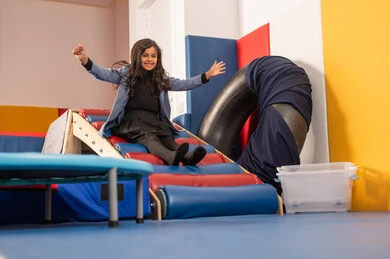 Enjoyable summer atmosphere, amusement park in the Kingdom of Saudi Arabia, a Gulf Arab Omani girl enjoying sliding down the slide, enjoying recreational games, fun and entertainment games.