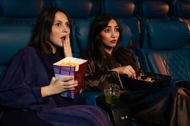 تجربة سينمائيه خياليه ، مشاهدة الأفلام المرعبه والعروض المسرحية في السينما، تعابير الخوف والذعر ،الاثارة والتشويق والاندماج ، قضاء أوقات ممتعة، صديقتان عربيتان سعوديتان خليجيتان في صالة السينما ، الإستمتاع بتناول الفشار والمشروبات الباردة ، سينما ومسرح، خلفية قاعة عرض السينما، صالة العرض