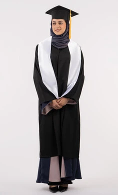 Standing up straight and taking a selfie, portrait of a smiling Saudi Arabian Gulf woman wearing a graduation cap and gown looking at something with an expression of pleasure and happiness, Emirati graduate celebrating the completion of university, concept of excellence, success and diligence, full body, white background