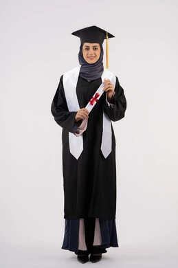 The concept of success and excellence, a young Saudi woman looking at the camera with gestures of pride, gestures of happiness for achieving her dream, a university occasion and celebration, a celebration of completing university studies, a portrait of a veiled Arab Gulf Emirati graduate wearing a graduation gown and cap, holding a certificate in her hand, white background