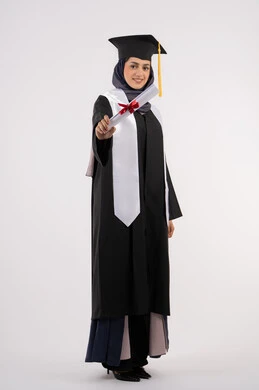 University occasion and celebration, a young Saudi woman looking at the camera with gestures of pride, expressions of happiness for achieving her dream, the concept of success and excellence, celebrating the completion of university studies, a portrait of a veiled Arab Gulf Emirati graduate wearing a graduation gown and cap, holding a certificate in her hand, white background