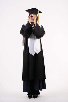 Future vision after graduation, portrait of a smiling young Saudi Arabian Gulf Arab woman wearing a cap and graduation gown holding a diploma like a telescope, Emirati graduate celebrating the end of her university studies, success, excellence and diligence, full body, white background