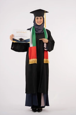 Pointing the index finger at the certificate, success, excellence, and graduation from university, gestures of happiness for achieving the dream, a university occasion and celebration, celebrating the completion of university studies, a portrait of a veiled Arab Gulf Emirati female graduate wearing a graduation gown and hat, looking at the camera, white background