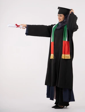 Looking at a place with gestures of pride, success, excellence and graduation from university, gestures of happiness for reaching the dream, a university occasion and celebration, celebrating the completion of university studies, a portrait of a veiled Arab Gulf Emirati graduate wearing a graduation outfit and hat holding a certificate in her hand, white background