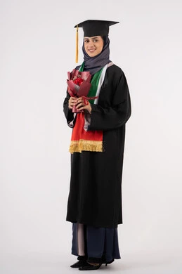 University occasion and celebration, celebration of completing university studies, gestures of happiness for reaching the dream of success, portrait of a veiled Arab Gulf Emirati graduate wearing graduation dress and cap, holding a bouquet of flowers in her hand, looking at the camera with an expression of pleasure, full body, white background