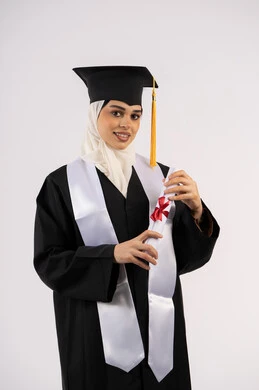Emirati graduate celebrating the completion of university, expressions of femininity and kindness, taking selfies in graduation gown, portrait of a smiling young Saudi Arabian Gulf woman wearing a graduation cap and gown, holding a certificate and looking at the camera with gestures of pleasure and joy, white background